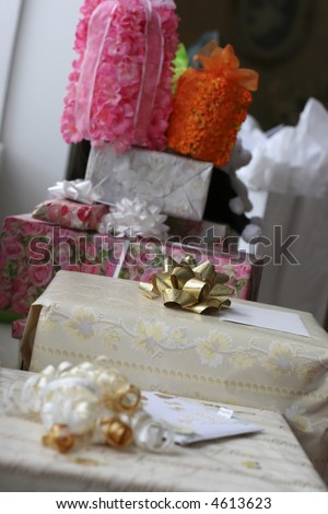 Several gift-wrappped wedding gifts of various sizes next to each other