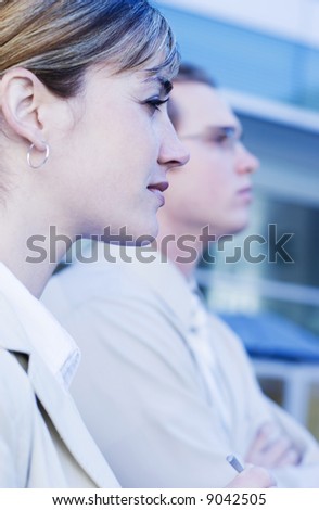 profile view of businesspeople standing side by side looking forward