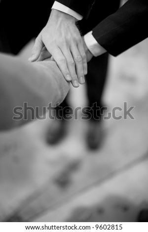 close-up of three businessmen hands on top of each other