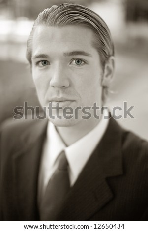 Close-up portrait of handsome businessman dressed in full suit and tie