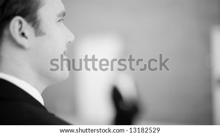 over the shoulder view of white businessman in suit
