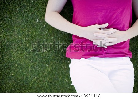 body of young woman on top of grass relaxing