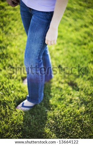 sandals jeans legs and waist of young woman outside