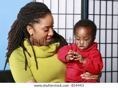 Mother holds her child as he eats a cookie