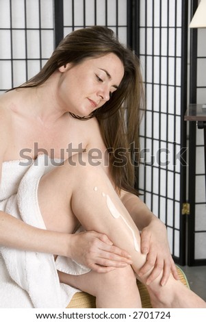 Woman using skin cream after a bath