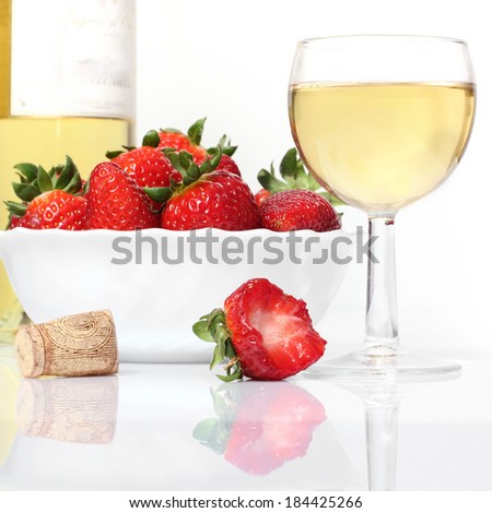 whie  wine bottle and glass and fresh strawberries isolated on white