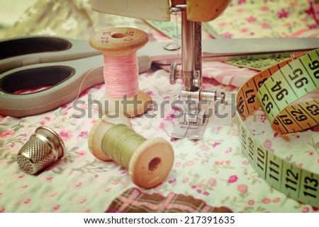 sewing machine, dressmaker scissors and thread-style retro