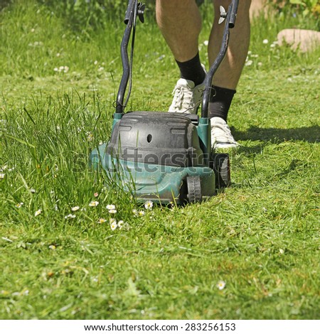 Man mowing grass with grass-mower