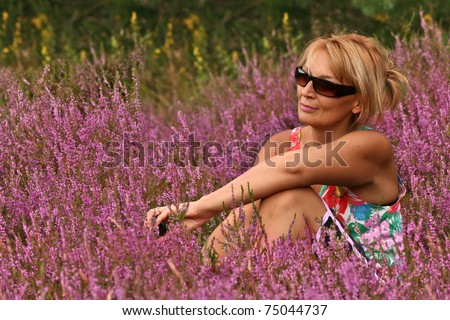 A naturally view. Mature  blond woman shot in a field