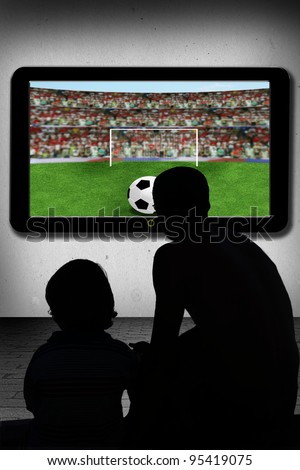 father and son  watching soccer ball  in television