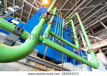 Equipment, cables and piping as found inside of a industrial power plant