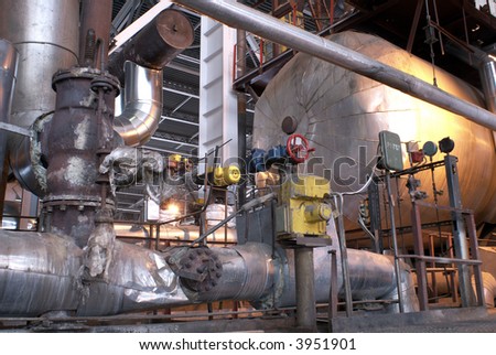 an assortment of different size and shaped pipes at a power plant.