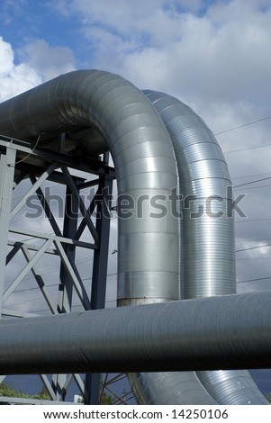 industrial pipelines on pipe-bridge against blue sky