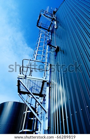 Industrial zone, Steel tanks and stairs against blue sky