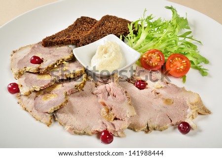 Baked ham with horseradish and bread on a plate