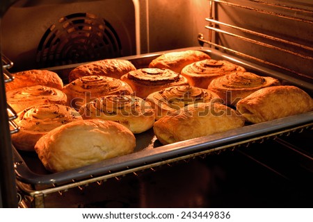 Baked cakes on a tray in the oven.