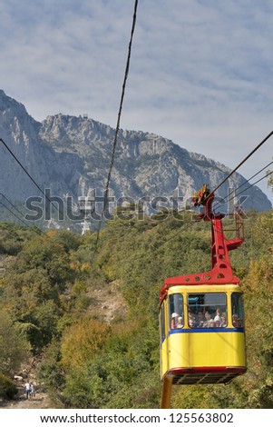 MISHOR, CRIMEA, UKRAINE - SEPTEMBER 16: People travel by rope way cab on top of Ai-Petri Mountain on September 16, 2012 in Mishor, Ukraine. This road has one of the longest unsupported span in Europe.
