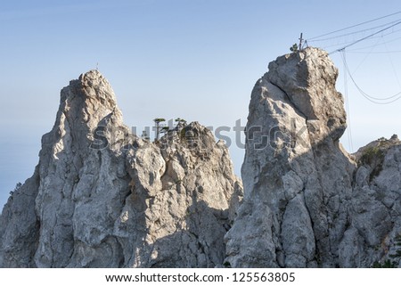 Two cliffs and equipment for mountain climbing and rappelling fixed on the rock. Ai-Petri, Crimea, Ukraine.