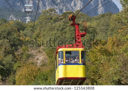 MISHOR, CRIMEA, UKRAINE - SEPTEMBER 16: People travel by rope way cab on top of Ai-Petri Mountain on September 16, 2012 in Mishor, Ukraine. This road has one of the longest unsupported span in Europe.