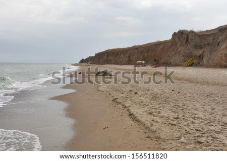 people have a rest at sea cloudy beach. Black Sea, Ukraine.