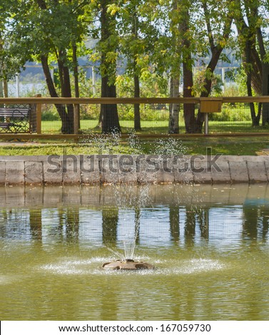 small fountain in the public park pond