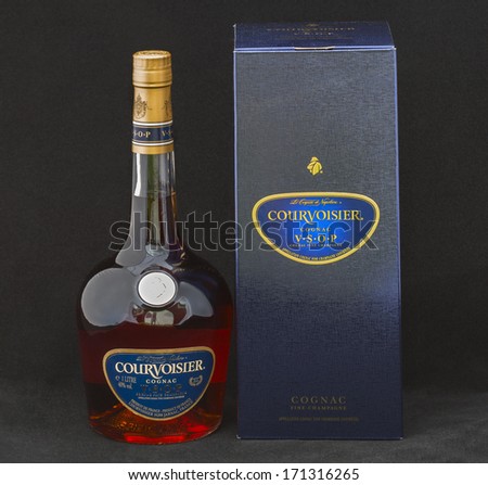 KIEV, UKRAINE - MAY 06, 2012: Courvoisier V.S.O.P. (very superior old pale) Cognac bottle and box against black. It is a luxury brand of French cognac established by Felix Courvoisier in 1835.