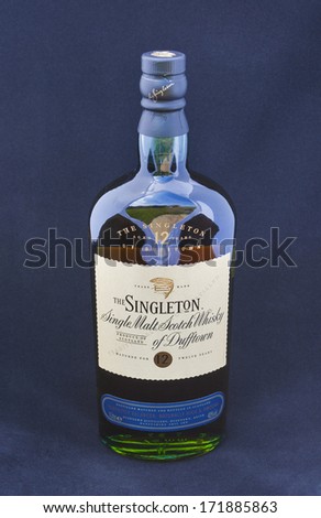 KIEV, UKRAINE - JUNE 06, 2012: Bottle of 12 years old Singleton Single Malt Scotch Whisky of Dufftown against blue background. Singleton brand owned by Diageo, the world\'s biggest whisky producer.