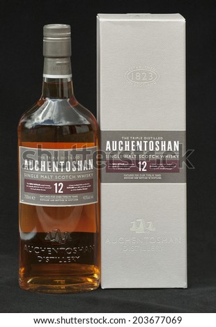 KIEV, UKRAINE - JUNE 29, 2012: Bottle and box of 12 years old single malt scotch whisky Auchentoshan against black. Auchentoshan single malt whisky distillery was built in 1800 in the west of Scotland