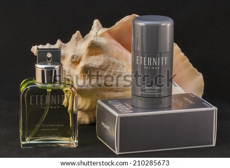 KIEV, UKRAINE - JULY 14, 2014: Calvin Klein Eternity for men fragrance and deodorant bottle and pack against black. Eternity for men fragrance was created by Carlos Benaim and was launched in 1989.