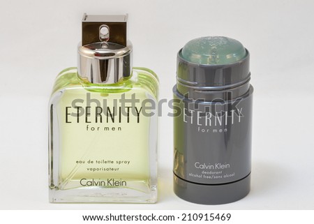 KIEV, UKRAINE - July 14, 2014: Calvin Klein Eternity for men fragrance bottle and opened deodorant stick against white. Eternity for men fragrance was created by Carlos Benaim and was launched in 1989