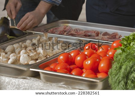 man hands cooking meet, mushrooms and vegetables
