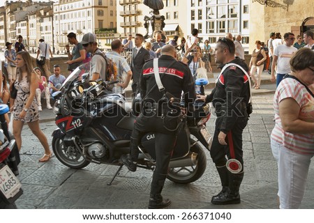 FLORENCE, ITALY - SEPTEMBER 09, 2014: Carabinieri work among the people crowd on Ponte Vecchio. It is the national military police of Italy, policing both military and civilian populations.