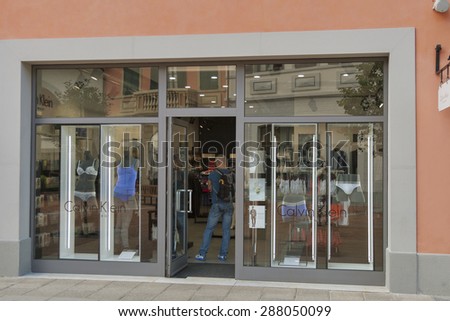 MUGELLO, ITALY - SEPTEMBER 11, 2014: People visit Calvin Klein Underwear store in McArthurGlen Designer Outlet Barberino. Calvin Klein is an American fashion house headquartered in Manhattan, New York