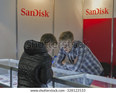 KIEV, UKRAINE - OCTOBER 11, 2015: People visit SanDisk, American electronics manufacturer company booth during CEE 2015, the largest electronics trade show of Ukraine in ExpoPlaza Exhibition Center