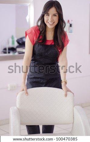 Beautiful latin woman greeting customers in her hair and beauty salon