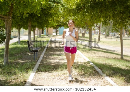 Cute latin woman running at the park