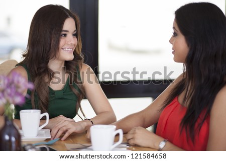 Beautiful young women sharing the latest gossip at a coffee shop