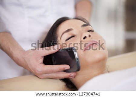 Taking a call while relaxing at a health and beauty spa