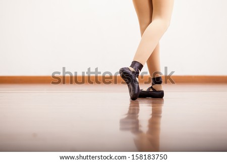 Closeup of a ballerina\'s feet while performing and wearing ballet shoes