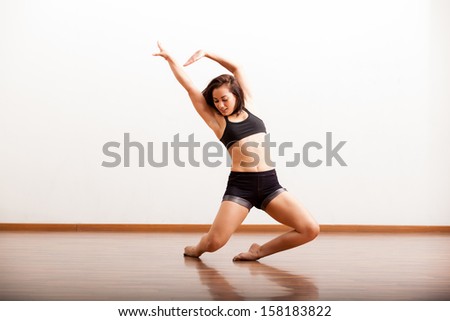 Cute female jazz dancer during a dance rehearsal in a studio