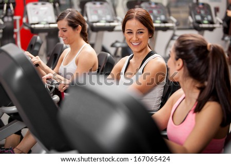 Group of cheerful female friends chatting and enjoying their class in a gym