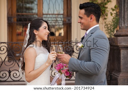 Romantic couple making a toast with champagne on their wedding day
