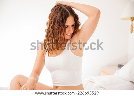 Happy young brunette showing off her recently depilated and smooth armpits