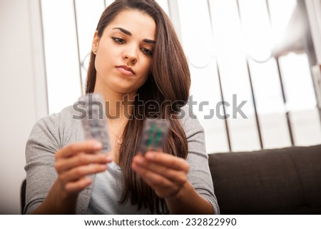 Cute brunette trying to figure out what medicine is best for her