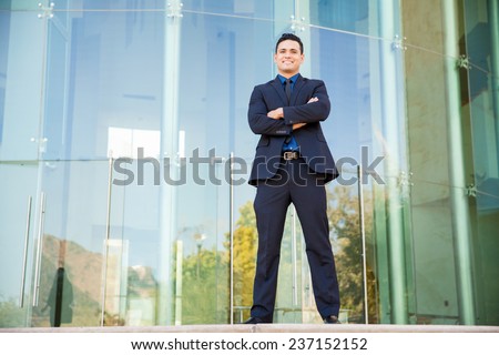 Full length portrait of an attractive young Latin businessman standing in front of a building