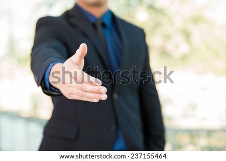 Closeup of a businessman extending his hand for a handshake