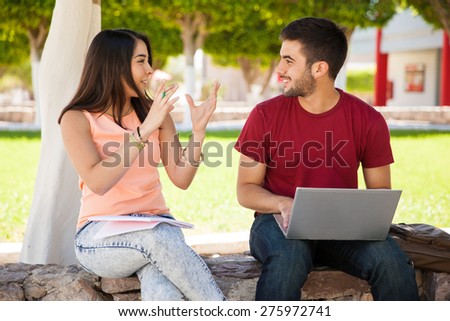 Cute girl and a friend of hers hanging out and talking about their recent school project