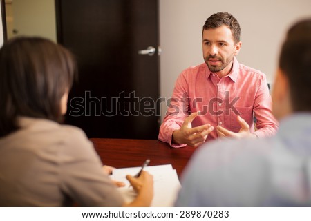 Portrait of an attractive young man talking about himself during a job interview