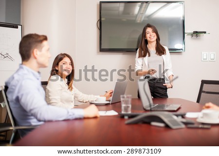 Portrait of a gorgeous young woman giving a business presentation in a meeting room