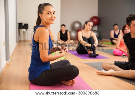 Portrait of a cute young Latin woman enjoying her yoga class in a gym